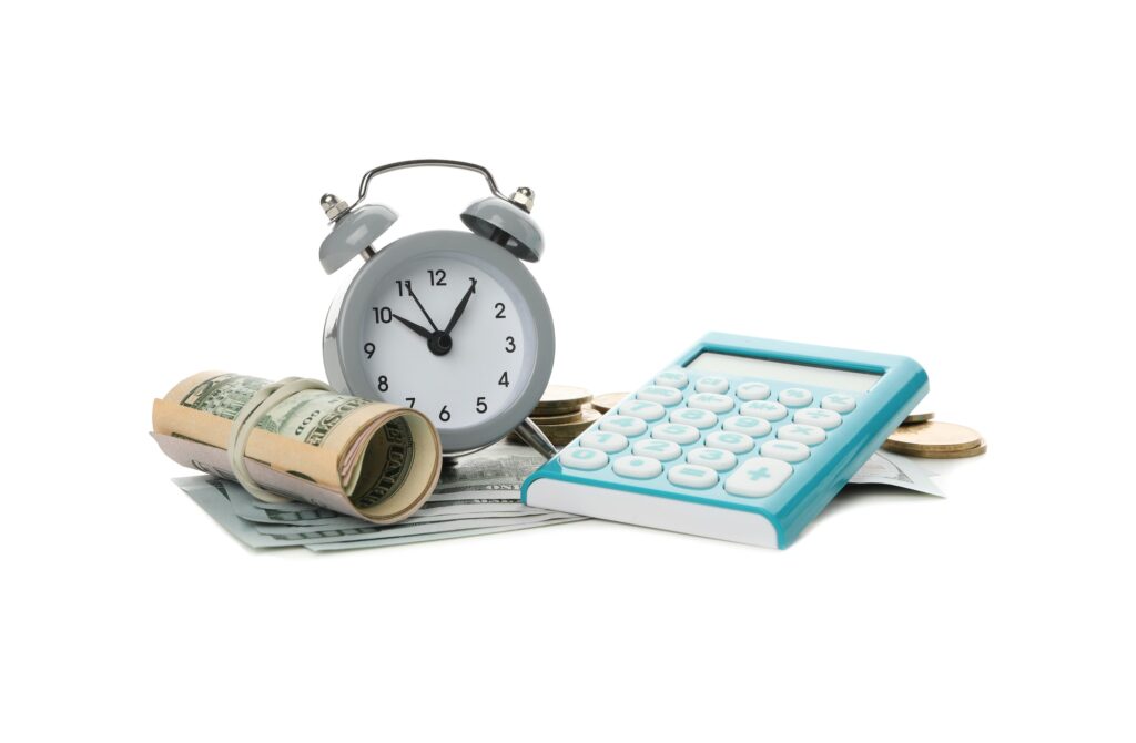 Calculator, alarm clock and money isolated on white background